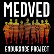 A dark image features the word "MEDVED" in large white capital letters at the top, and "ENDURANCE PROJECT" in similar lettering at the bottom. Between the two text elements are silhouettes of eight runners in motion, layered one behind the other. The silhouettes are filled with a horizontal gradient of colors, transitioning from yellow at the top to orange and then red at the bottom, creating a striated effect within each runner.