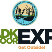 Logo for the ADK Outdoor Expo. At the top is a circular seal for the Adirondack Mountain Club - Genesee Valley Chapter, featuring silhouettes of flying ducks and cattails against a yellow and blue sky, with the motto "Working for Wilderness" at the bottom. Below the seal, the main text reads "ADK OUTDOOR EXPO" in a bold font, with "ADK OUTDOOR" in green and "EXPO" in large black letters with an orange target-like center in the letter 'O'. At the very bottom, the tagline "Get Outside!" is written in orange script.